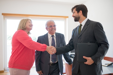 an agent shakes hands with people