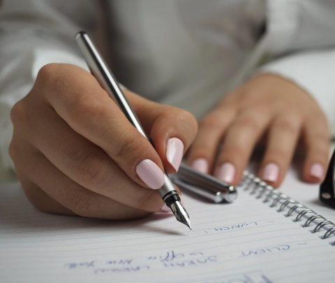 close up of someone writing plans in a notebook